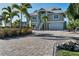 Two-story waterfront home with a paved driveway at 1910 Oregon Trl, Englewood, FL 34224