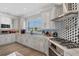 Modern kitchen with stainless steel appliances and marble countertops at 1910 Oregon Trl, Englewood, FL 34224