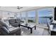 Living room with floor to ceiling windows and water views at 1910 Oregon Trl, Englewood, FL 34224