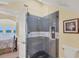 Sleek gray tiled shower with glass enclosure at 1910 Oregon Trl, Englewood, FL 34224