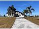 Two-story home with paver driveway and palm trees at 5061 Collingswood Blvd, Port Charlotte, FL 33948