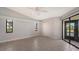 Spacious bedroom featuring tile floors, a ceiling fan, a closet, and sliding glass door leading to the screened lanai at 3830 Bal Harbor Blvd # 9, Punta Gorda, FL 33950