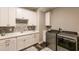 Bright laundry room with white cabinets and modern appliances at 1728 Twin Rivers Trl, Parrish, FL 34219