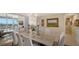 Elegant dining room with marble table and access to balcony at 3040 Grand Bay Blvd # 283, Longboat Key, FL 34228