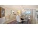 Elegant dining room with modern light fixtures and access to balcony at 3040 Grand Bay Blvd # 283, Longboat Key, FL 34228