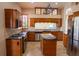 Island kitchen with stainless steel appliances and granite countertops at 326 Saint George Ct # 14, Venice, FL 34293