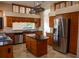 Island kitchen with stainless steel appliances and granite countertops at 326 Saint George Ct # 14, Venice, FL 34293