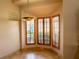 Bright dining area with wood-trimmed windows and plantation shutters at 326 Saint George Ct # 14, Venice, FL 34293