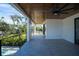 Second story balcony with views of tropical foliage, a wood ceiling, and a modern black railing at 2111 Hawthorne St, Sarasota, FL 34239