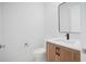 Stylish powder room with wood vanity and contemporary fixtures at 2111 Hawthorne St, Sarasota, FL 34239