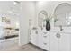 Elegant bathroom featuring a double vanity, stone countertop, and brushed bronze fixtures at 2111 Hawthorne St, Sarasota, FL 34239