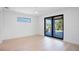 Bright bedroom with light wood floors and access to a private balcony at 2111 Hawthorne St, Sarasota, FL 34239