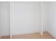 A walk-in closet, painted white with wood flooring at 2111 Hawthorne St, Sarasota, FL 34239