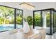 Close up of the bright dining room, focusing on the decor and views of the pool and backyard at 2111 Hawthorne St, Sarasota, FL 34239