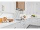 Bright kitchen with white cabinets, quartz countertops, stainless steel appliances, and modern fixtures at 2111 Hawthorne St, Sarasota, FL 34239