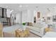 Open-concept living area with stairs, tile floors, contemporary furnishings, and adjacent to the modern kitchen at 2111 Hawthorne St, Sarasota, FL 34239