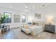 A cozy main bedroom with neutral tones, decorative pillows, artwork and natural lighting at 2111 Hawthorne St, Sarasota, FL 34239