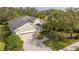 Single-story house with a tile roof, driveway, and lush landscaping at 12327 Thornhill Ct, Lakewood Ranch, FL 34202