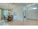 Bright dining room with chandelier, tile flooring, and entry to the front of the home at 12327 Thornhill Ct, Lakewood Ranch, FL 34202