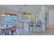 Eat-in kitchen boasts white cabinetry, modern lighting, and granite countertops at 12327 Thornhill Ct, Lakewood Ranch, FL 34202