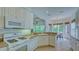 Well-equipped kitchen with white cabinets, granite countertops, and modern appliances at 12327 Thornhill Ct, Lakewood Ranch, FL 34202