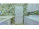 Laundry room with washer, dryer, and patterned wallpaper at 12327 Thornhill Ct, Lakewood Ranch, FL 34202