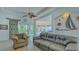 Bright living room featuring a comfortable seating area and view into the kitchen at 12327 Thornhill Ct, Lakewood Ranch, FL 34202