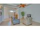 Living area showcasing a gray couch, entryway, and a view into another room at 12327 Thornhill Ct, Lakewood Ranch, FL 34202