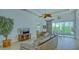 Spacious living room with leather sofas, large windows, and access to a patio at 12327 Thornhill Ct, Lakewood Ranch, FL 34202