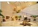 Elegant lobby with high ceilings, a grand staircase, and plenty of plants at 12327 Thornhill Ct, Lakewood Ranch, FL 34202