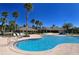 Freeform community pool with surrounding lounge chairs at 12327 Thornhill Ct, Lakewood Ranch, FL 34202