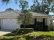 Charming single-story home featuring a well-maintained front lawn and an attached two-car garage at 909 Barclay Ct, Venice, FL 34293