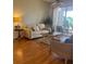Inviting living room with hardwood floors and access to a peaceful outdoor patio at 909 Barclay Ct, Venice, FL 34293