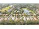 Aerial view showing a house's position within a residential area featuring golf course proximity at 12327 Thornhill Ct, Lakewood Ranch, FL 34202
