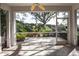 Spacious screened patio with lush landscaping and a view of nature at 909 Barclay Ct, Venice, FL 34293