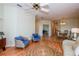 Comfortable living room featuring hardwood floors and wicker chairs at 909 Barclay Ct, Venice, FL 34293