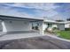 Covered carport with attached storage and a nicely landscaped front yard at 1810 University Pl # 6, Sarasota, FL 34235