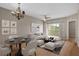 Living room with light wood floors, chandelier, and access to a balcony at 9505 Amberdale Ct # 201, Riverview, FL 33578