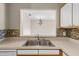 Modern double sink with a view into the living room at 9505 Amberdale Ct # 201, Riverview, FL 33578