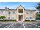 Tan two-story condo building with stairs and landscaping at 9505 Amberdale Ct # 201, Riverview, FL 33578