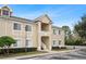 Tan two-story condo building with stairs and landscaping at 9505 Amberdale Ct # 201, Riverview, FL 33578