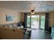 Living room with water views and access to balcony at 10469 Waterbird Way, Bradenton, FL 34209