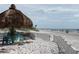 Relaxing beach scene with white sand, a thatched umbrella, and seating at 10469 Waterbird Way, Bradenton, FL 34209