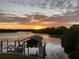Breathtaking sunset over the calm water, with a boat lift visible at 10469 Waterbird Way, Bradenton, FL 34209