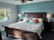 King-size bed in a well-lit bedroom with water views at 10469 Waterbird Way, Bradenton, FL 34209