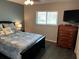 Guest bedroom with full-size bed and dresser at 10469 Waterbird Way, Bradenton, FL 34209