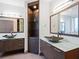 Modern bathroom with dual vanities and glass shelving at 340 S Palm Ave # 15, Sarasota, FL 34236