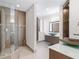Modern bathroom with glass shower, dual vanities, and stone countertops at 340 S Palm Ave # 15, Sarasota, FL 34236