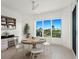 Dining area with a round table, white chairs, and views of the city skyline at 340 S Palm Ave # 15, Sarasota, FL 34236