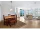 Open concept dining area with hardwood floors and access to living room at 340 S Palm Ave # 15, Sarasota, FL 34236